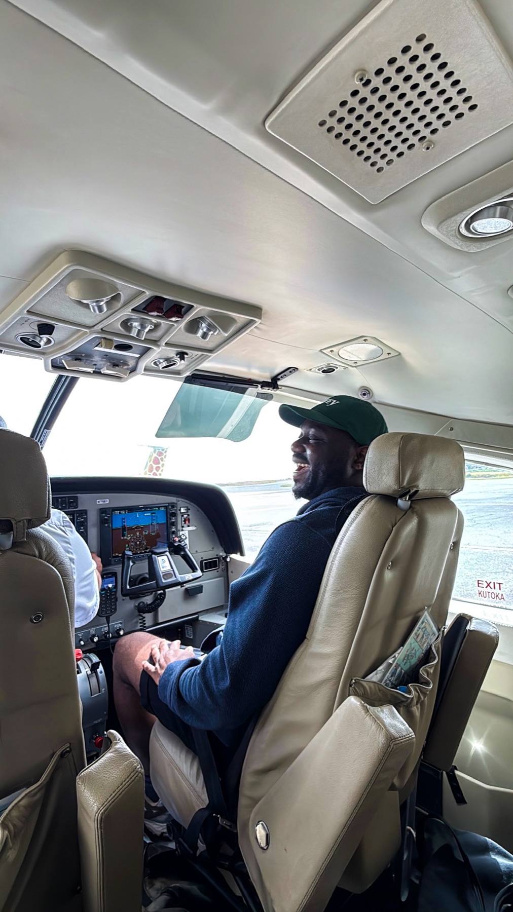 Daniel laughing inside a small aircraft during a trip